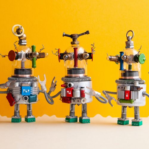 Funny glass headed ufo robots on a fantastic landscape. Three humanoid toy robots communicate.